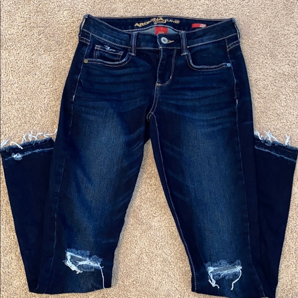 Super skinny blue jeans with rips at the knee